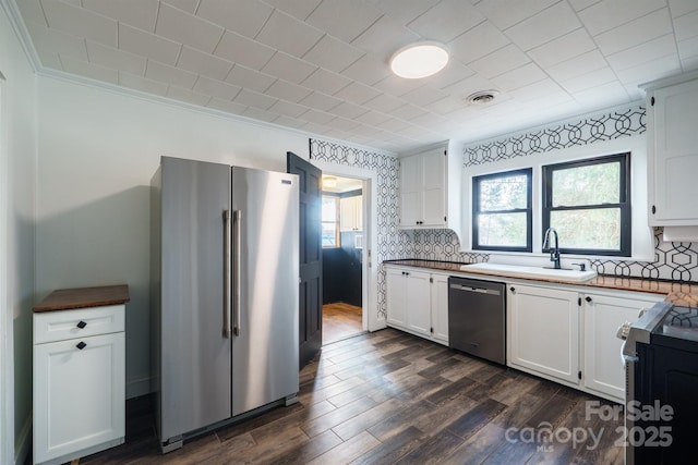 kitchen with white cabinetry, sink, dark wood-type flooring, and appliances with stainless steel finishes