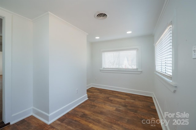 unfurnished room featuring dark wood-type flooring and crown molding