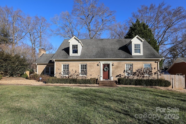 cape cod home with a front lawn