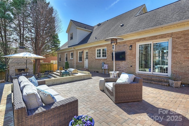 view of patio / terrace with entry steps and an outdoor living space with a fireplace