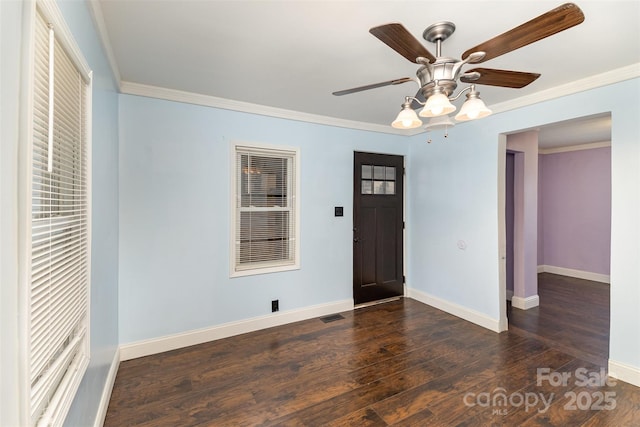 entryway featuring dark wood-type flooring, ceiling fan, and ornamental molding