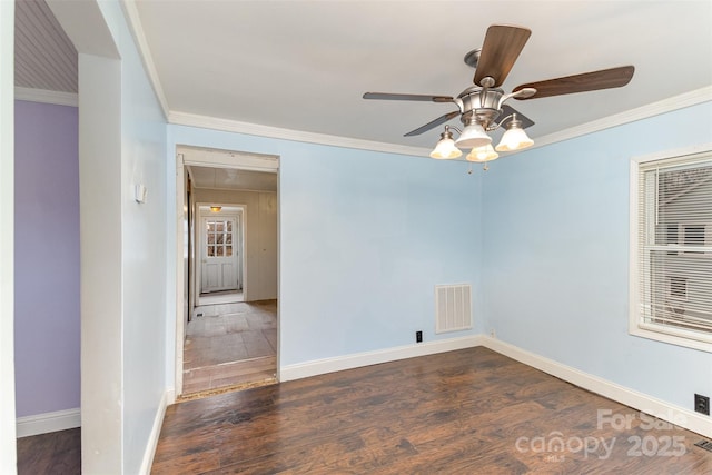 empty room featuring ceiling fan, ornamental molding, and dark hardwood / wood-style floors