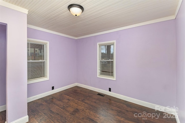 spare room featuring crown molding and dark hardwood / wood-style floors