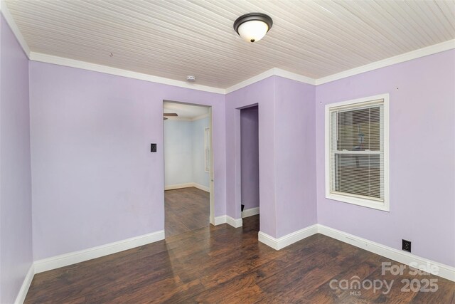 spare room with wood ceiling, ornamental molding, and dark hardwood / wood-style floors