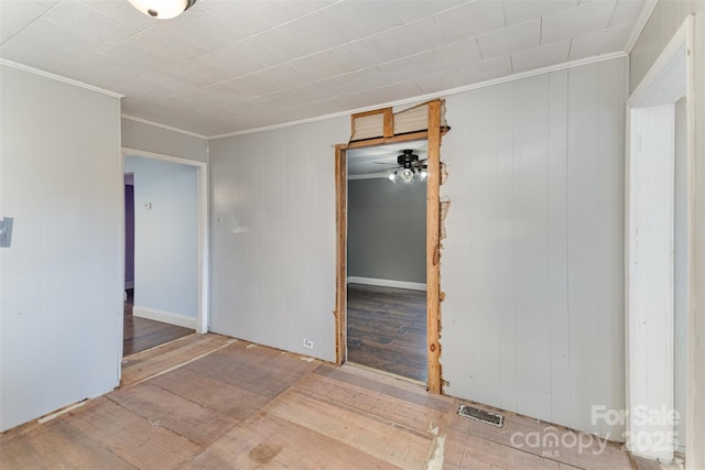 unfurnished room featuring ornamental molding and hardwood / wood-style floors