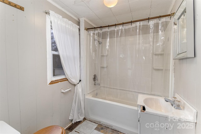 bathroom featuring shower / tub combo, vanity, wooden walls, and ornamental molding