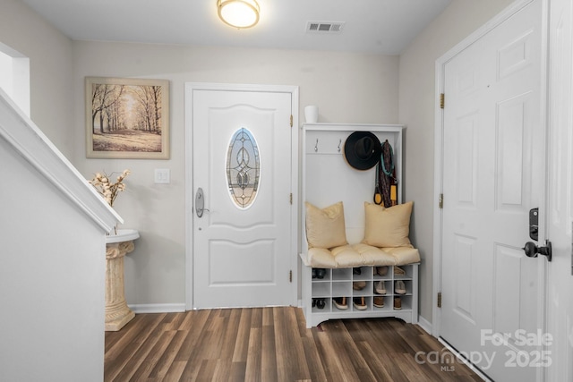 foyer entrance with visible vents, baseboards, and dark wood-style flooring