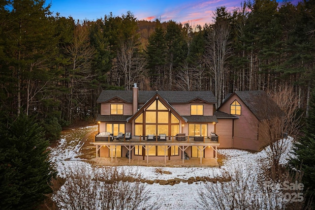 snow covered property featuring a wooden deck