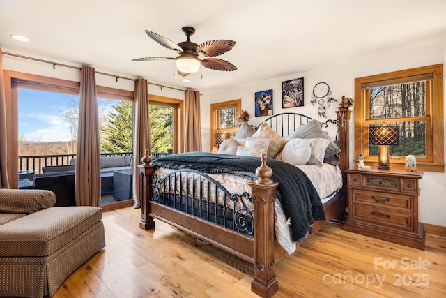 bedroom with access to exterior, light hardwood / wood-style floors, and ceiling fan