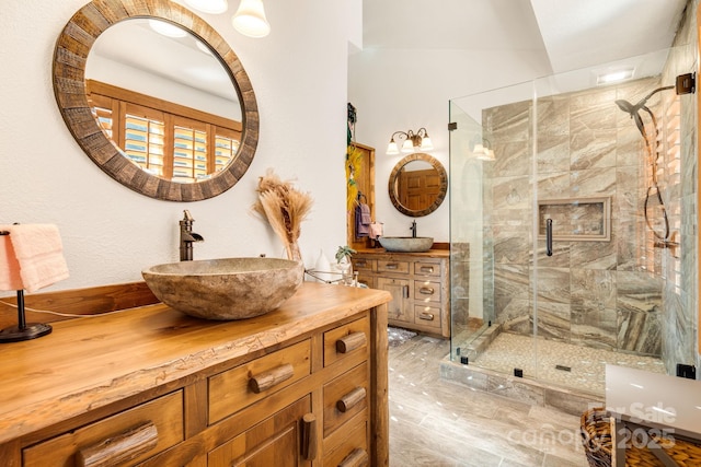 bathroom with vanity and a shower with door