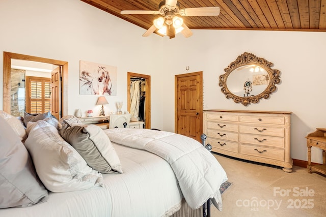 carpeted bedroom featuring wood ceiling, a walk in closet, lofted ceiling, and a closet