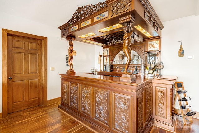 bar with hardwood / wood-style flooring