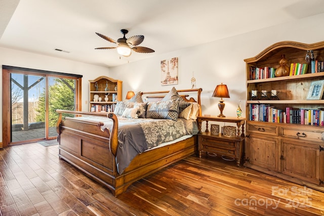 bedroom with ceiling fan, access to exterior, and dark hardwood / wood-style flooring