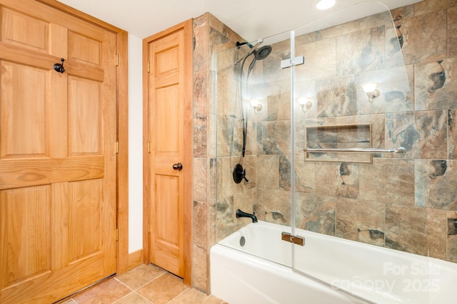 bathroom featuring tile patterned flooring and combined bath / shower with glass door