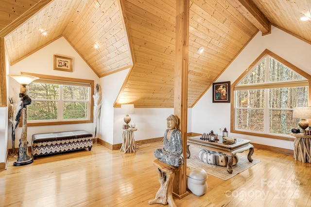 living area with lofted ceiling with beams, wood-type flooring, and wood ceiling