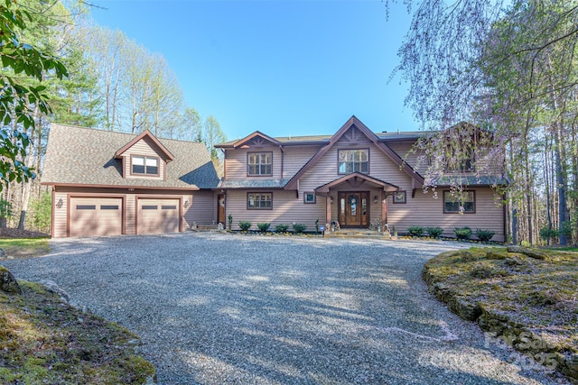 craftsman-style home with gravel driveway and an attached garage