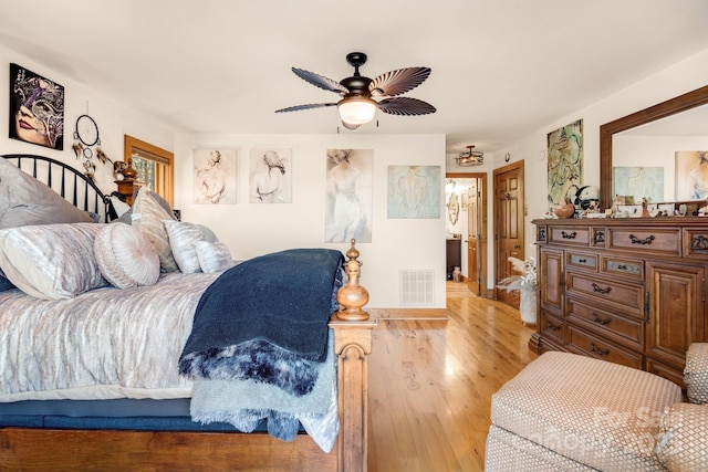 bedroom featuring wood finished floors, visible vents, and ceiling fan