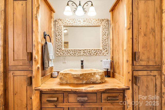 bathroom featuring vanity and a notable chandelier
