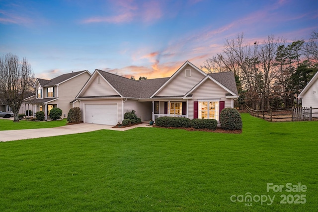 view of front of house with a garage and a lawn