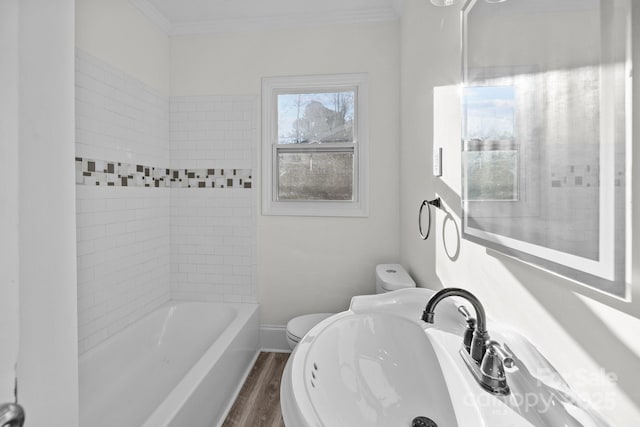 full bathroom with toilet, sink, crown molding, tiled shower / bath, and wood-type flooring