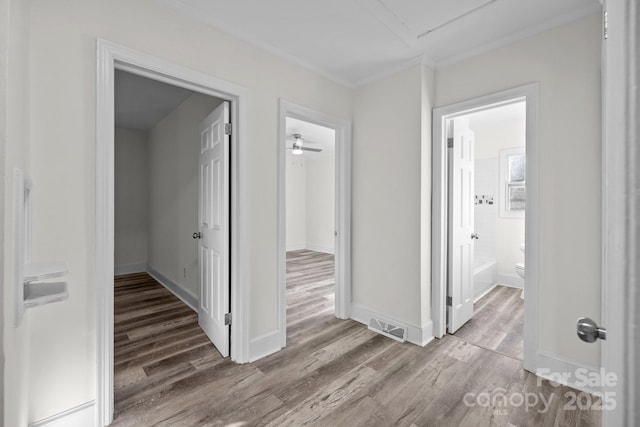 hall featuring crown molding and hardwood / wood-style floors