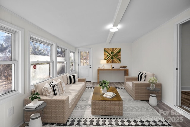 sunroom / solarium with vaulted ceiling with beams