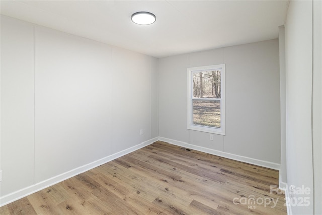 unfurnished room with light hardwood / wood-style floors