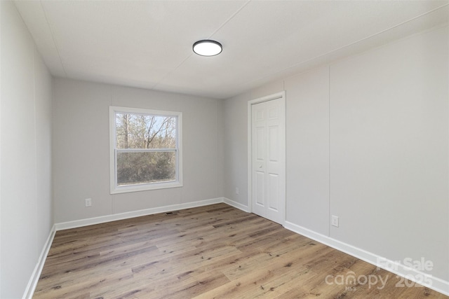 empty room with light hardwood / wood-style flooring