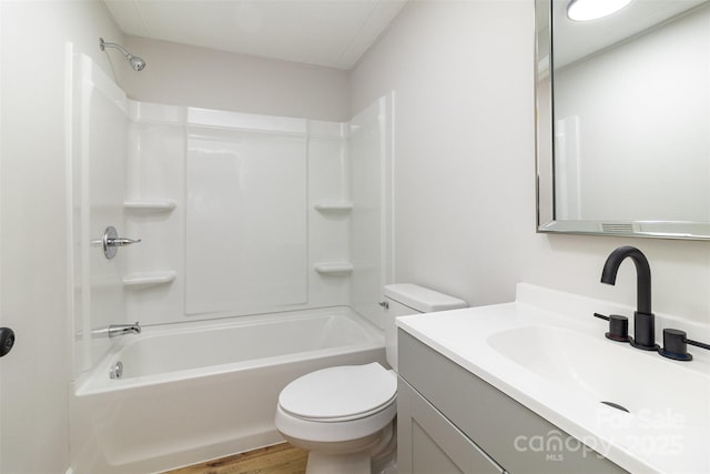 full bathroom with vanity, hardwood / wood-style floors, toilet, and shower / bath combination