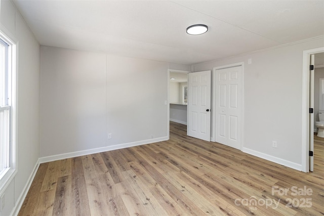 spare room featuring plenty of natural light and light hardwood / wood-style flooring