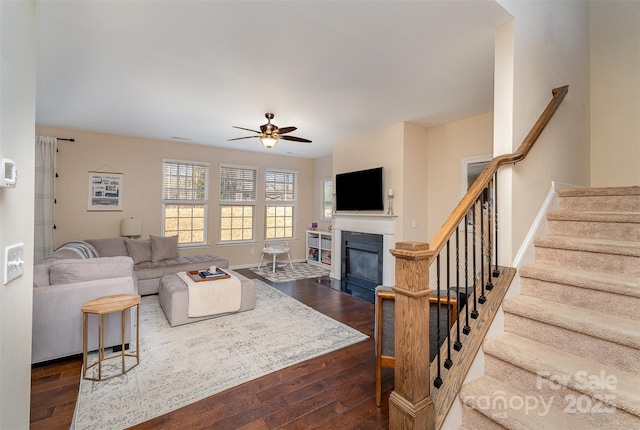 living room featuring dark hardwood / wood-style floors and ceiling fan