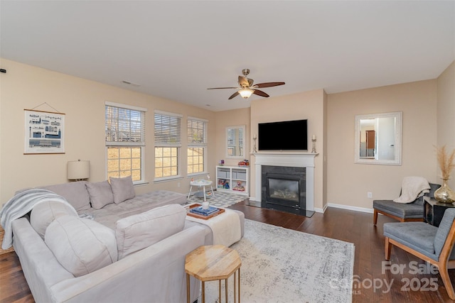 living room with dark wood-type flooring and ceiling fan