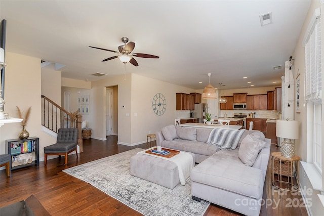 living room with dark hardwood / wood-style flooring, sink, and ceiling fan