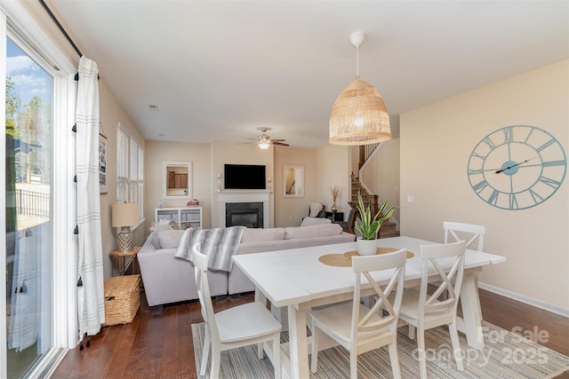 dining space featuring dark hardwood / wood-style flooring and ceiling fan