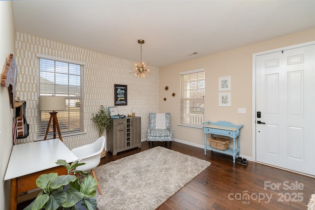 sitting room featuring a notable chandelier and dark hardwood / wood-style floors