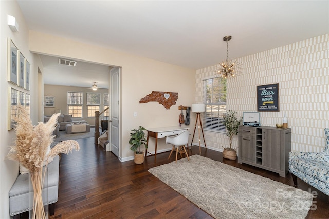 interior space with dark hardwood / wood-style flooring and ceiling fan with notable chandelier