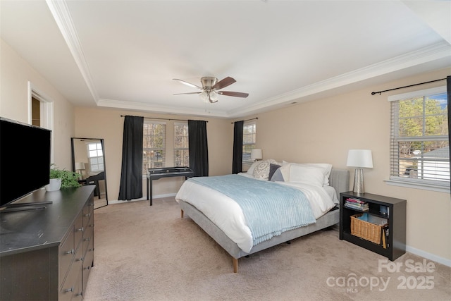 bedroom with multiple windows, crown molding, a raised ceiling, and light colored carpet