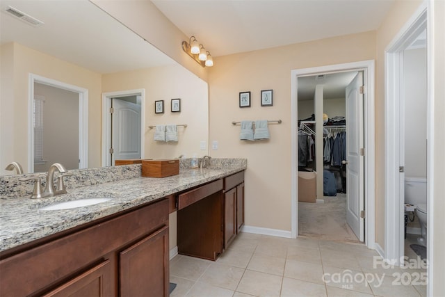 bathroom with tile patterned floors, vanity, and toilet