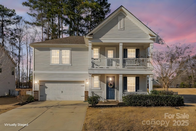 232 Morgans Branch Rd, Belmont, NC 28012 - view of front of home with a balcony, covered porch, a garage, concrete driveway, and brick siding