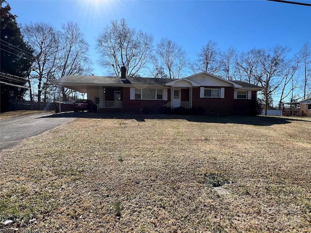 ranch-style home with a front lawn and a carport