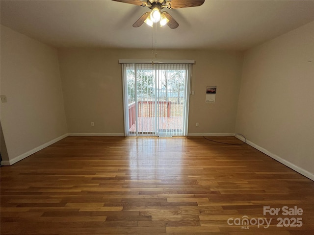 spare room with ceiling fan and dark hardwood / wood-style flooring