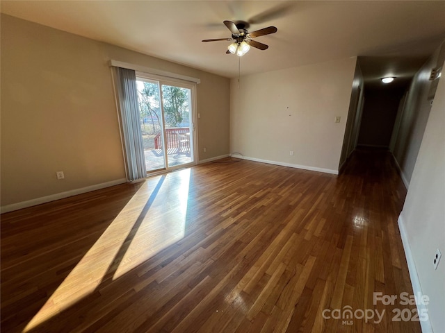 empty room with dark wood-type flooring and ceiling fan