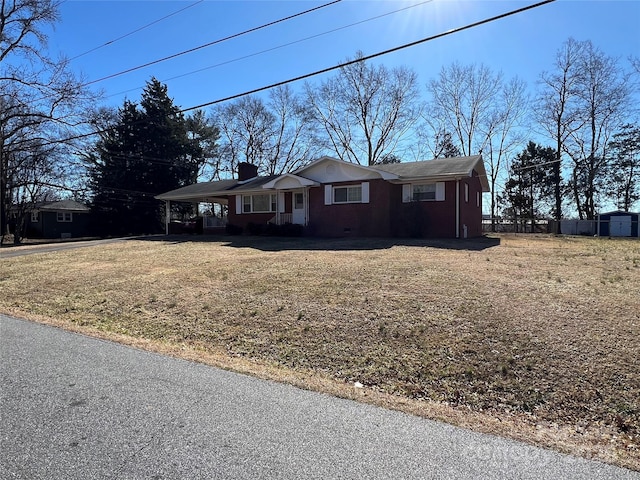 single story home with a carport and a front lawn