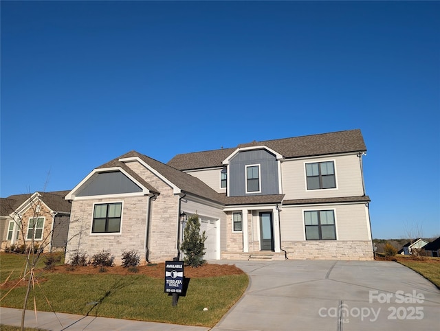 view of front of property with a garage and a front lawn