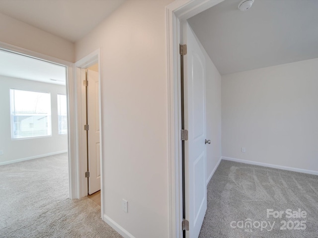 hall with light colored carpet