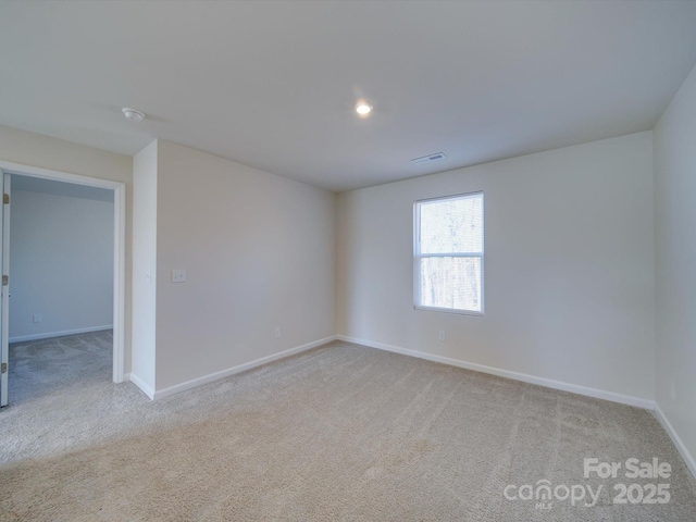 empty room featuring light colored carpet