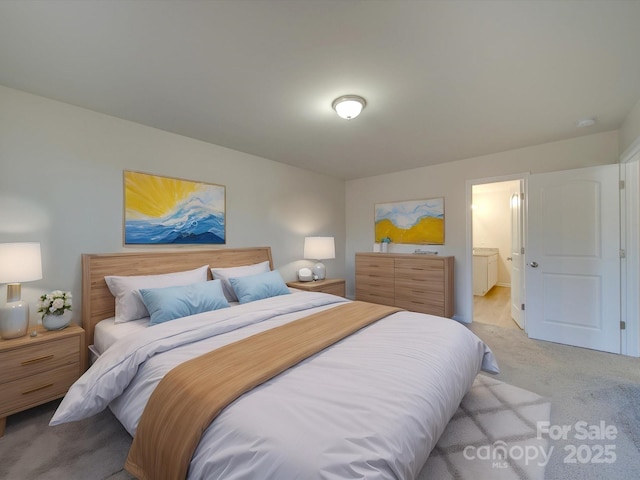 bedroom with light carpet and ensuite bathroom