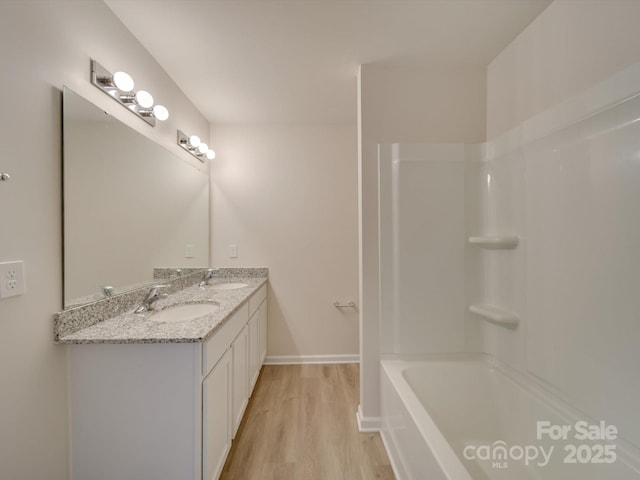 bathroom with vanity, hardwood / wood-style flooring, and shower / bathing tub combination