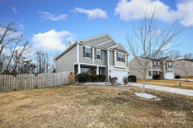 view of property with a garage and a front lawn