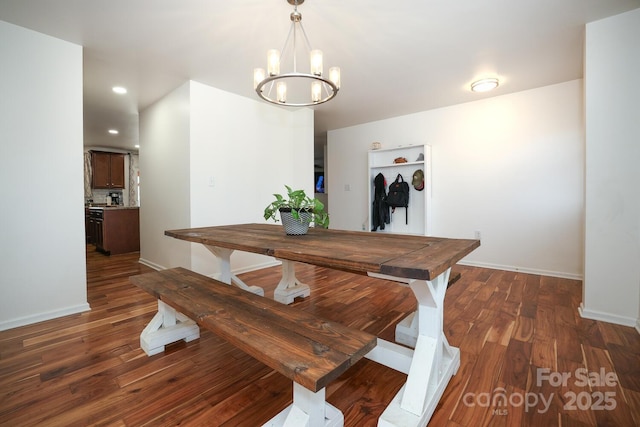 dining room featuring a notable chandelier and dark hardwood / wood-style flooring